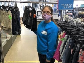 An LCS Participant Sorts Clothes at Goodwill