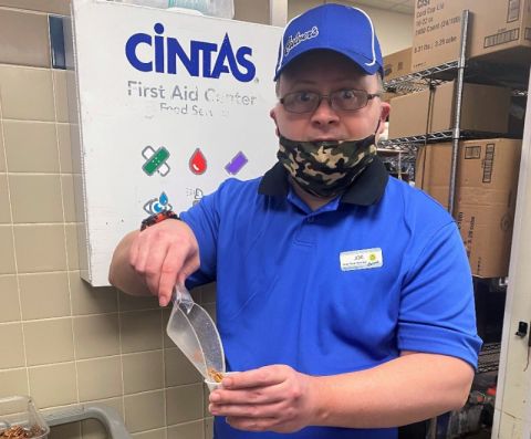 An LCS participant fills cups with food toppings at Culver's