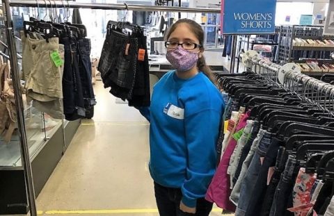 An LCS Participant Sorts Clothes at Goodwill