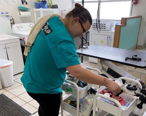 An LCS participant preparing to help give a dog bath at Clover Pup